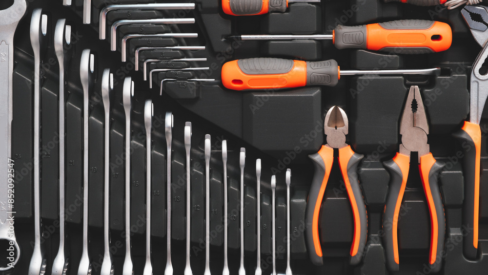Poster A toolbox with many different tools including pliers, wrenches, and screwdrivers. The tools are organized in a way that makes it easy to find what you need