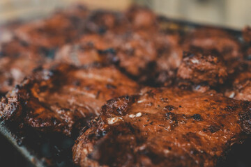 Man hand grilling barbecue with smoked pork at backyard on day. Family dinner outdoor style bbq activity