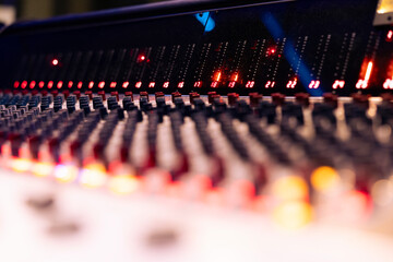 Pre amp knobs and buttons on mixing console panel board control desk, audio technical gear used in music post production. Modern tools and equipment in professional studio. Close up.