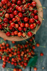Ripe cherries on a wooden background, top view