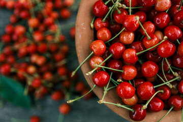 Ripe cherries on a wooden background, top view