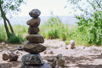 Pile of rough stones stacked on the shore symbolizes balance and tranquility
