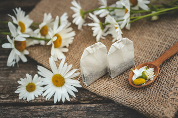 A bag of chamomile tea. Herbal chamomile tea in a bag on wooden background