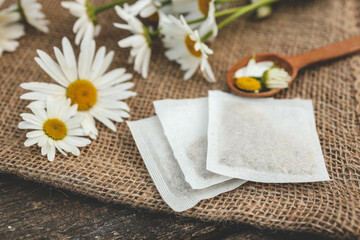 A bag of chamomile tea. Herbal chamomile tea in a bag on wooden background