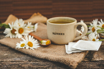 A bag of chamomile tea. Herbal chamomile tea in a bag on wooden background