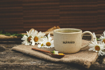 A bag of chamomile tea. Herbal chamomile tea in a bag on wooden background