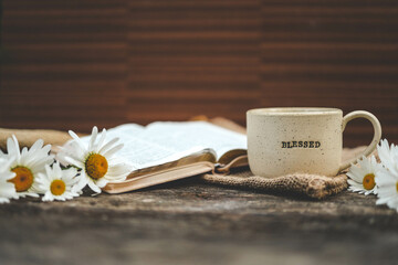 Cup with the inscription blessed and open Bible, Christian concept