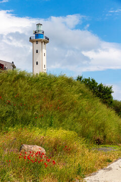 View of the Aheloy lighthouse with May vegetation in front at the Aheloy Marina, Pomorie Municipality, Burgas Province, Bulgarian Black Sea coast