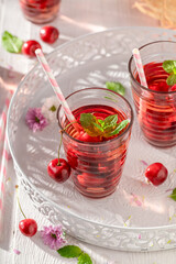 Healthy and tasty lemonade with cherries and crushed ice.
