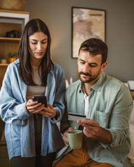 Boyfriend and girlfriend buy online on cellphone with credit card