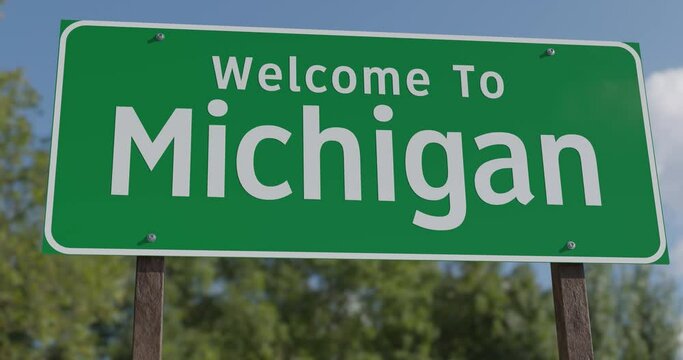 Driving By A Welcome To Michigan Green Road Sign Against a Blue Sky and Clouds.
