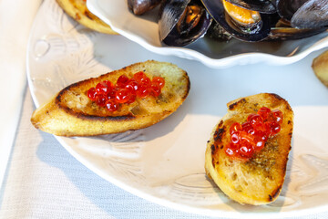 Red wild salmon caviar roe with pesto French bread sauce
