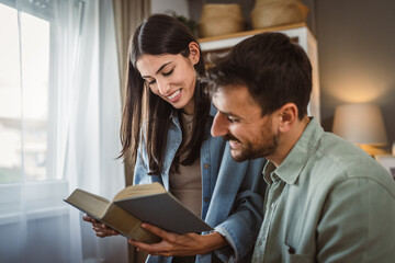 Girlfriend and boyfriend read a book together at living room