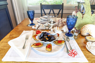 Clamshell dish of mussels and garlic with red wild salmon caviar roe