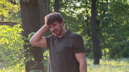 Young man suffering from mosquito bites in the forest