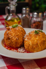 Close-Up of Crispy Arancini with Marinara Sauce