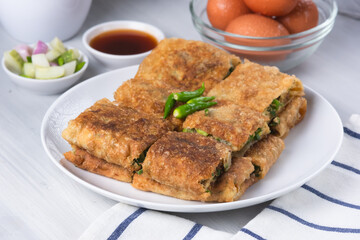 Martabak telur is a food with a savory taste. Contains vegetables, meat and various other spices.. Perfect for recipe, article, or any cooking contents.