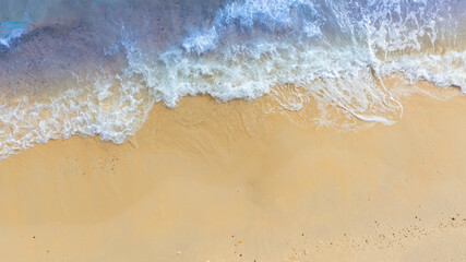 Top view beach sand background for summer vacation concept. Beach nature and summer seawater with sunlight light sandy beach Sparkling sea water	