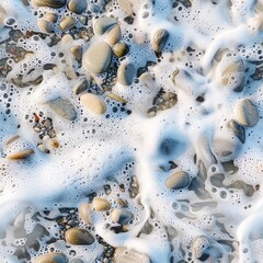Fototapeta premium A close-up of white sea foam swirling around the shoreline pebbles, capturing the delicate textures and natural cleansing action of the ocean