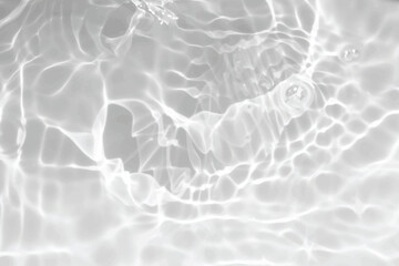 White water with ripples on the surface. Defocus blurred transparent white colored clear calm water surface texture with splashes and bubbles. Water waves with shining pattern texture background.