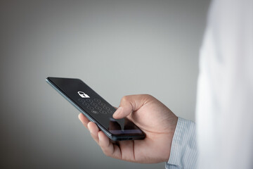 Phishing, mobile phone hacking or cyber scam concept. Password and login passcode in the smartphone. Online security threat and fraud. Person scammer with cellphone. Bank account security technology.