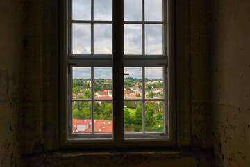 Fototapeta premium Blick durch ein historisches Sprossenfenster auf die Stadt Colditz von Schloss Colditz am 31. Mai 2024, Colditz, Landkreis Leipzig, Sachsen, Deutschland