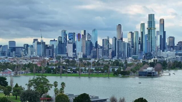 Aerial across Albert Park Lake to the Melbourne city skyline