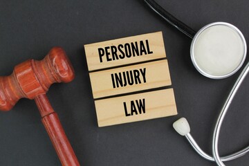 judge's gavel, stethoscope and stick with the words personal injury law