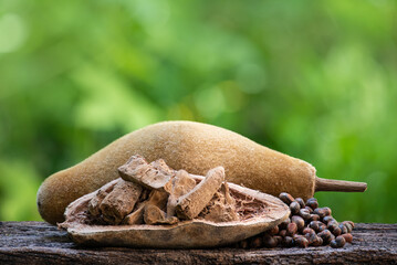 Dried baobab seeds and fruit on natural background.