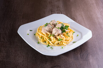 pasta dish with meatballs and white molgo.