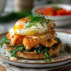 a gourmet serving of salmon benedict with deliciously poached eggs with hollandaise sauce, served on a freshly toasted bread, garnished with leafy greens and sprinkled with herbs and spices