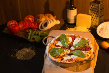 Delicious pizza made with lots of cheese, buffalo mozzarella, sun-dried tomatoes and arugula