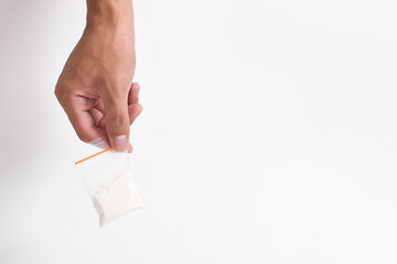 Hand giving cocaine in plastic package isolated on white background. Illustration of illegal drug substances, narcotics