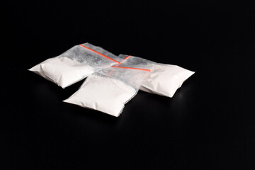 Cocaine in plastic packet isolated on black background. illustration of illegal drug substances, narcotics