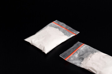 Cocaine in plastic packet isolated on black background. illustration of illegal drug substances, narcotics