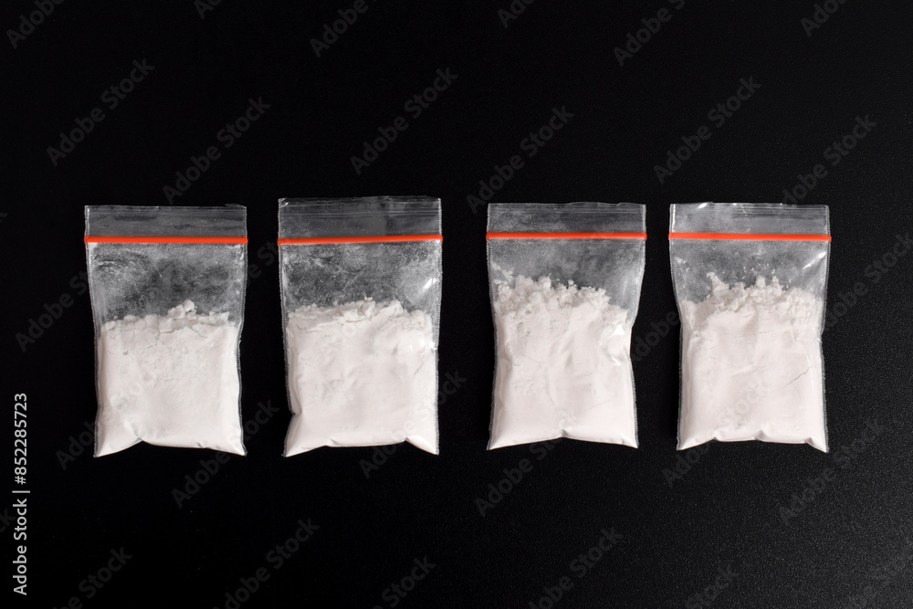 Wall mural cocaine in plastic packet isolated on black background. illustration of illegal drug substances, nar