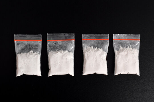 Cocaine in plastic packet isolated on black background. illustration of illegal drug substances, narcotics