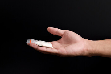 Hand holding Cocaine in plastic packet isolated on black background. illustration of illegal drug...