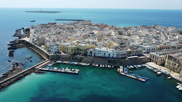 Aerial 4K footage of  Gallipoli showing the old town with it's fort, ramparts and harbor, located in Lecce province, Salento peninsula, Puglia, southern Italy