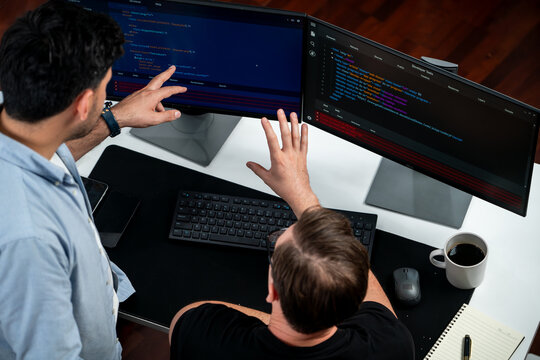 IT developers discussing online software development information on pc screen, creating program coding for latest version application on website. Concept of brainstorming firmware updated. Sellable.