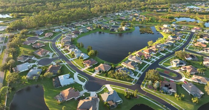 View from above of waterfront neighborhood in Florida with suburban houses. Development of US premium housing