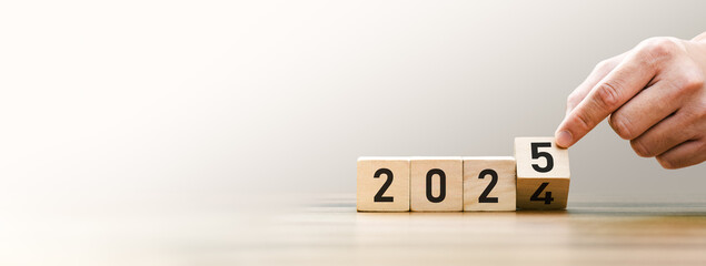 Transitioning from 2024 to 2025 with wooden blocks symbolizing target business for the upcoming...