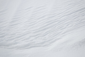 White ripples in fresh winter snow abstract texture background
