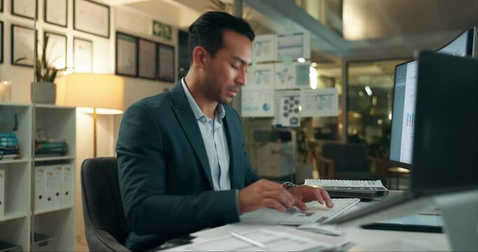 Busy, office and man checking watch with deadline, pressure and overtime with paperwork at computer. Late, night and frustrated businessman at desk with time management crisis, stress and overworked