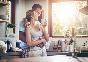 Coffee, hug and love with couple in kitchen of home together for morning break or wellness. Cup, smile or tea with happy man and woman drinking fresh beverage in apartment for love or romance