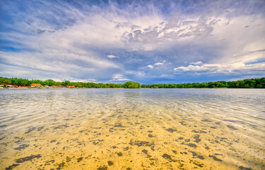 Big clouds floating over lake "De IJzeren Man" in The Netherlands.
