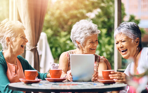 Cafe, laughing and tablet with elderly women at table outdoor together for bonding or social media. Funny, happy or smile with senior friends at sidewalk coffee shop, tech for app or memories