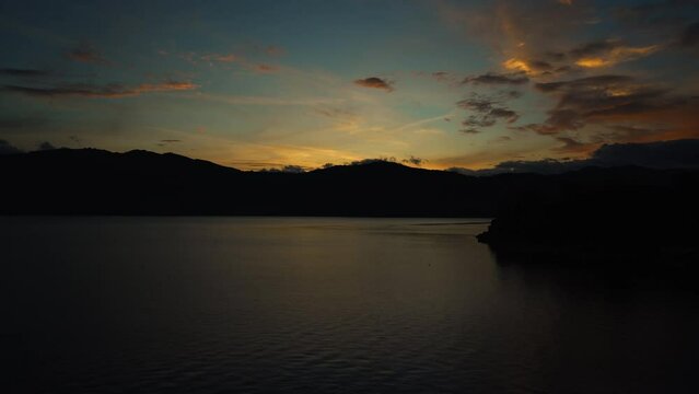 morning sunrise in lake atitlan guatemala in a timelapse showing much movement and fishing in foreground with mountains in background south america