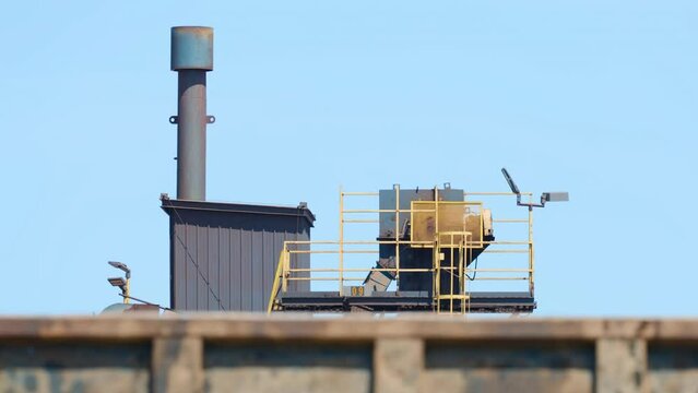 Industrial equipment in scrapyard recycling material delivered by dump trucks
