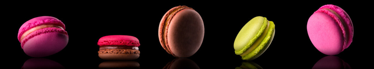 Macro photo of french caramel macaroon or macaron isolated on black background